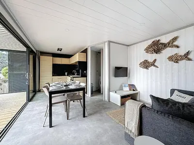 Télévision ou salle de divertissement dans l'établissement Cottage Le Béluga