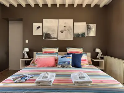 Un ou plusieurs lits dans un hébergement de l'établissement Chambre Le Mas du Bessin