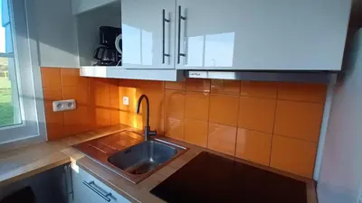 Cuisine ou kitchenette dans l'établissement VVF Camping Les Dunes Créances - Plage du Cotentin