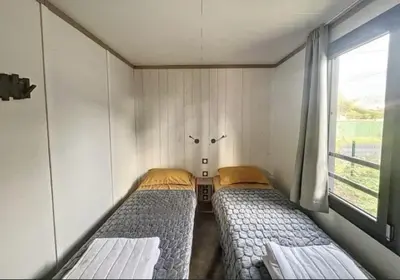 Un ou plusieurs lits dans un hébergement de l'établissement Le Cottage de Laura Jullouville 6 pers