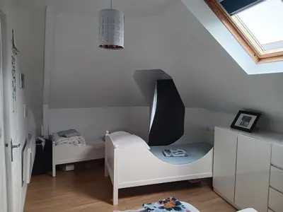 Un ou plusieurs lits dans un hébergement de l'établissement Un nid cosy sous les toits