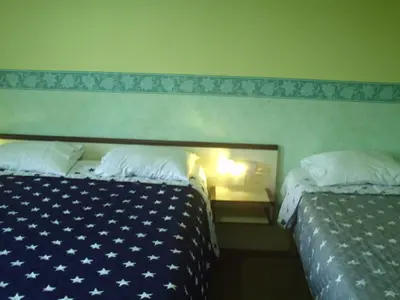 Un ou plusieurs lits dans un hébergement de l'établissement Hôtel l'Eden