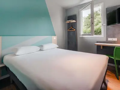 Un ou plusieurs lits dans un hébergement de l'établissement Ibis Budget Pontorson Baie Du Mont Saint Michel
