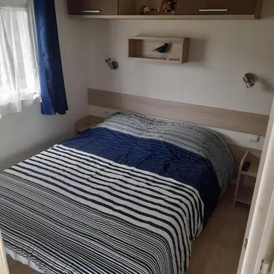 Un ou plusieurs lits dans un hébergement de l'établissement Mobilhome 4 personnes