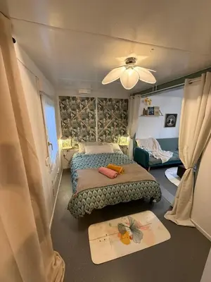 Un ou plusieurs lits dans un hébergement de l'établissement Le Petit Lodge