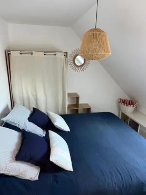 Un ou plusieurs lits dans un hébergement de l'établissement Appartement duplex VARAVILLE