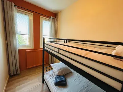 Un ou plusieurs lits dans un hébergement de l'établissement Espace Familiale Meublé 3 chambres