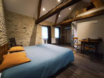 Un ou plusieurs lits dans un hébergement de l'établissement Omaha Secret Normandy Cottages