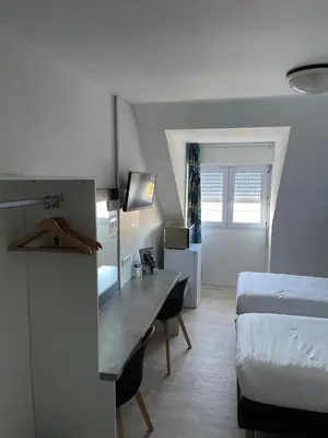 Un ou plusieurs lits dans un hébergement de l'établissement Brit Hotel Cherbourg