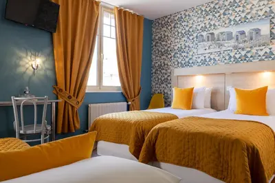 Un ou plusieurs lits dans un hébergement de l'établissement Hôtel de Lion sur Mer