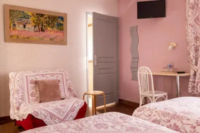 Un ou plusieurs lits dans un hébergement de l'établissement Hôtel de Lion sur Mer