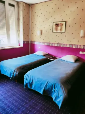 Un ou plusieurs lits dans un hébergement de l'établissement Hôtel Saint - Pierre
