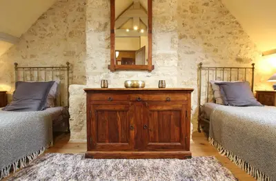 Un ou plusieurs lits dans un hébergement de l'établissement Gites Du Manoir de Savigny