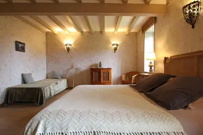 Un ou plusieurs lits dans un hébergement de l'établissement Gites Du Manoir de Savigny