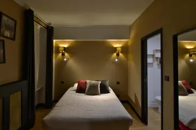 Un ou plusieurs lits dans un hébergement de l'établissement Hôtel Le Tiburon