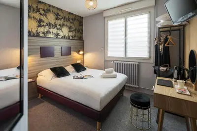 Un ou plusieurs lits dans un hébergement de l'établissement Hôtel du Musée