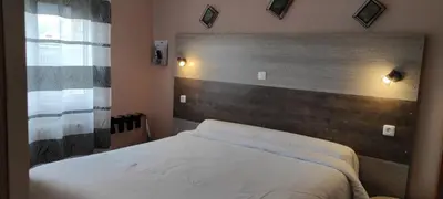 Un ou plusieurs lits dans un hébergement de l'établissement Hotel du 6 juin
