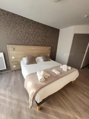 Un ou plusieurs lits dans un hébergement de l'établissement Logis Hôtel Au Moyne de Saire