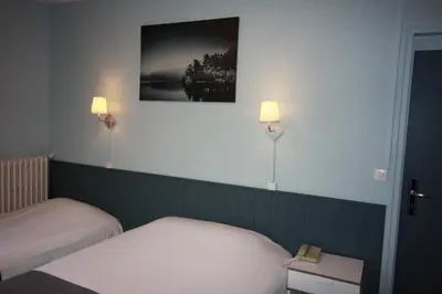 Un ou plusieurs lits dans un hébergement de l'établissement Hotel De l'Univers