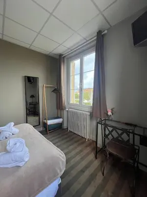 Un ou plusieurs lits dans un hébergement de l'établissement Hôtel Le Phare