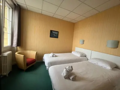 Un ou plusieurs lits dans un hébergement de l'établissement Hôtel Le Phare
