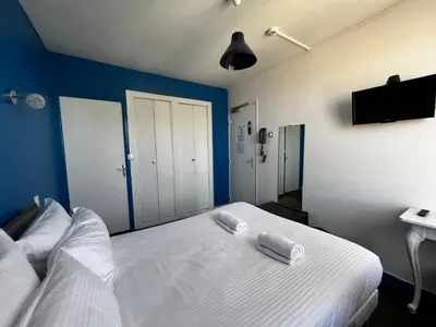 Un ou plusieurs lits dans un hébergement de l'établissement Contact Hotel Les Montois