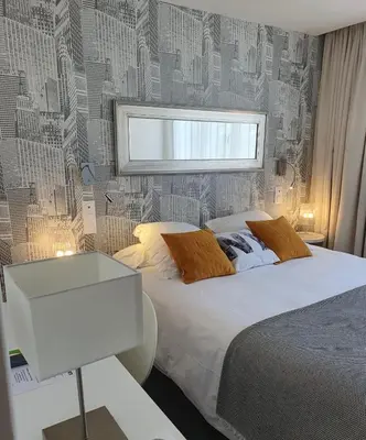 Un ou plusieurs lits dans un hébergement de l'établissement Hôtel Moderna