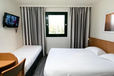 Un ou plusieurs lits dans un hébergement de l'établissement Hôtel Vert