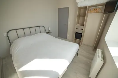 Un ou plusieurs lits dans un hébergement de l'établissement Appart Hotel de la Souleuvre