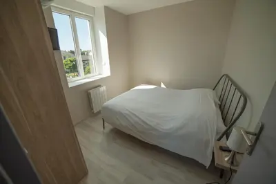 Un ou plusieurs lits dans un hébergement de l'établissement Appart Hotel de la Souleuvre