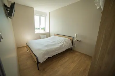 Un ou plusieurs lits dans un hébergement de l'établissement Appart Hotel de la Souleuvre