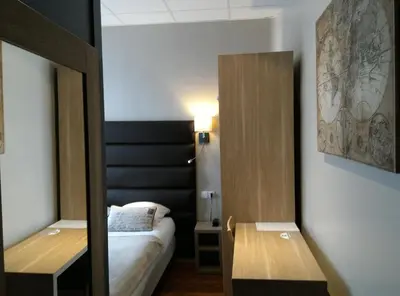 Un ou plusieurs lits dans un hébergement de l'établissement Hotel Napoléon