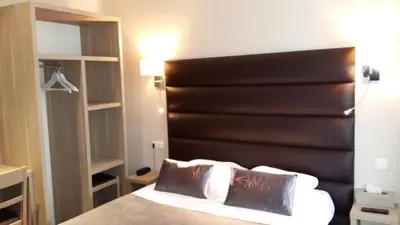 Un ou plusieurs lits dans un hébergement de l'établissement Hotel Napoléon
