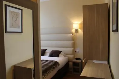 Un ou plusieurs lits dans un hébergement de l'établissement Hotel Napoléon