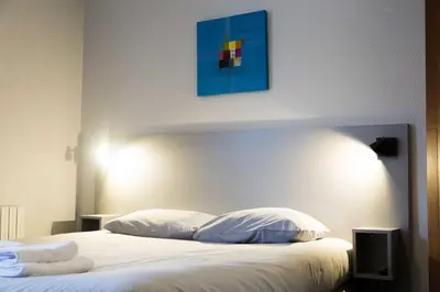 Un ou plusieurs lits dans un hébergement de l'établissement Smartappart Cherbourg (la rose des vents)