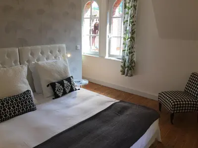 Un ou plusieurs lits dans un hébergement de l'établissement Gîte Les Ecuries du Manoir de Bénédicte
