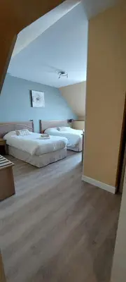 Un ou plusieurs lits dans un hébergement de l'établissement Hotel Beau Rivage