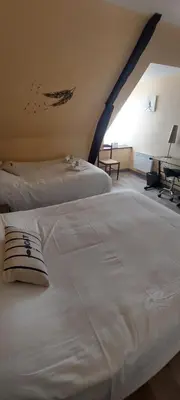 Un ou plusieurs lits dans un hébergement de l'établissement Hotel Beau Rivage