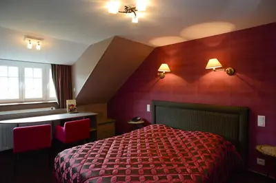 Un ou plusieurs lits dans un hébergement de l'établissement Hôtel de La Croix d'Or