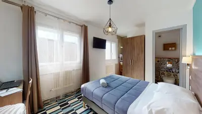 Un ou plusieurs lits dans un hébergement de l'établissement Hôtel Les Pieux En Cotentin