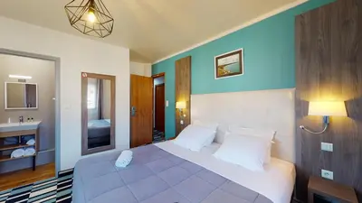 Un ou plusieurs lits dans un hébergement de l'établissement Hôtel Les Pieux En Cotentin