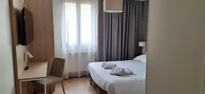 Un ou plusieurs lits dans un hébergement de l'établissement Hôtel Beaurivage