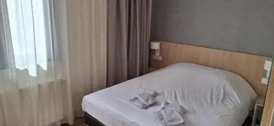 Un ou plusieurs lits dans un hébergement de l'établissement Hôtel Beaurivage