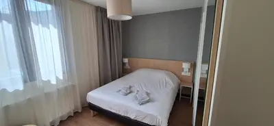 Un ou plusieurs lits dans un hébergement de l'établissement Hôtel Beaurivage