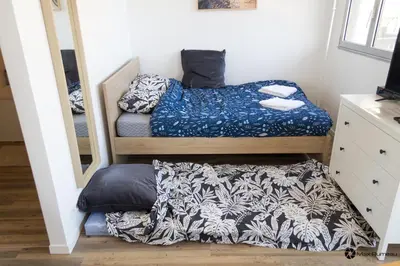 Un ou plusieurs lits dans un hébergement de l'établissement Studio moderne accès plage, piscine et tennis
