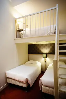 Un ou plusieurs lits dans un hébergement de l'établissement Le Relais Du Roy
