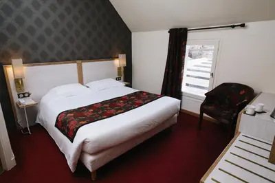 Un ou plusieurs lits dans un hébergement de l'établissement Le Relais Du Roy