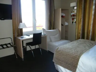 Un ou plusieurs lits dans un hébergement de l'établissement CIT'HOTEL Saint-Pierre