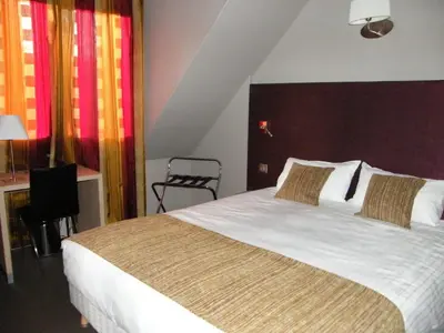 Un ou plusieurs lits dans un hébergement de l'établissement CIT'HOTEL Saint-Pierre
