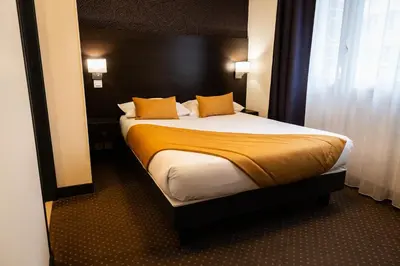 Un ou plusieurs lits dans un hébergement de l'établissement Hotel Astrid Caen centre